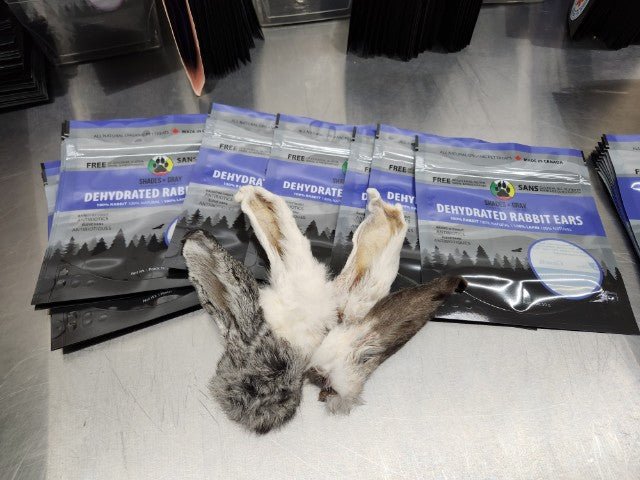 Dehydrated Rabbit Ears laid out in front of packages on display.