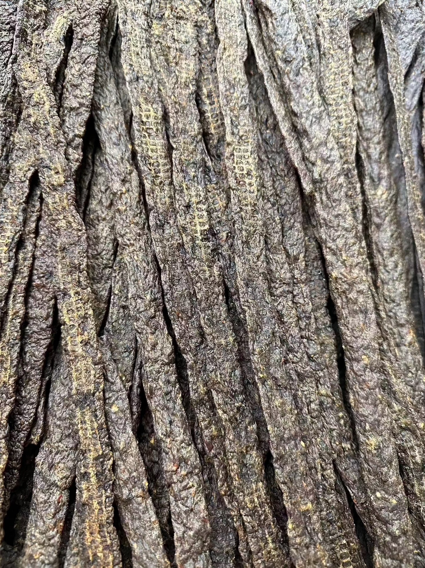 A large quantity of Venison Strip Pet Treats laid out in bulk.