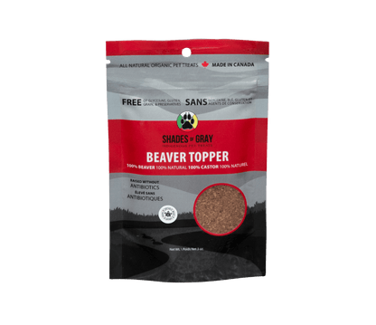 Front view of Shades of Gray Indigenous Pet Treats Beaver Topper 13 oz pouch with matte black and grey an red design, large white “BEAVER TOPPER” text, “Single Ingredient Dog & Cat Topper” subtitle, product window displaying real air-dried beaver meat in granular form, prominent Made in Ontario logo, Canadian flag icon, “100% Canadian Beaver”, and circular Shades of Gray Indigenous Pet Treats logo highlighting ethical Indigenous sourcing.