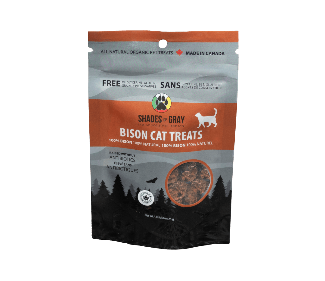 Front of Shades of Gray IndigenousPet Treats Bison Cat Treats packaging in sleek Brown/ black and grey resealable pouch, featuring bold “BISON CAT TREATS” lettering, “Single Ingredient” callout, clear window showing small pieces of dehydrated bison cat treats, Made in Ontario badge, Canadian flag, and circular Shades of Gray Indigenous Pet Treats logo.