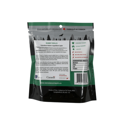 Back of a green Shades of Gray Rabbit Rolls bag, showing a single ingredient of rabbit, feeding instructions, and the guaranteed analysis panel. It lists humanely raised, locally grown, low fat, no antibiotics, no corn, wheat, or soy, and no additives or preservatives. Includes the Certified Aboriginal Business logo. Included in the Small Dog Bundle.