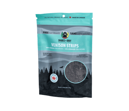 Front of Shades of Gray Indigenous Pet Treats Venison Strips packaging in premium Teal / black and grey resealable pouch, featuring bold white “VENISON STRIPS” lettering, single-ingredient callout, clear window showing long air-dried Canadian venison strips, Made in Ontario badge, Canadian flag, and circular Shades of Gray Indigenous Pet Treats logo