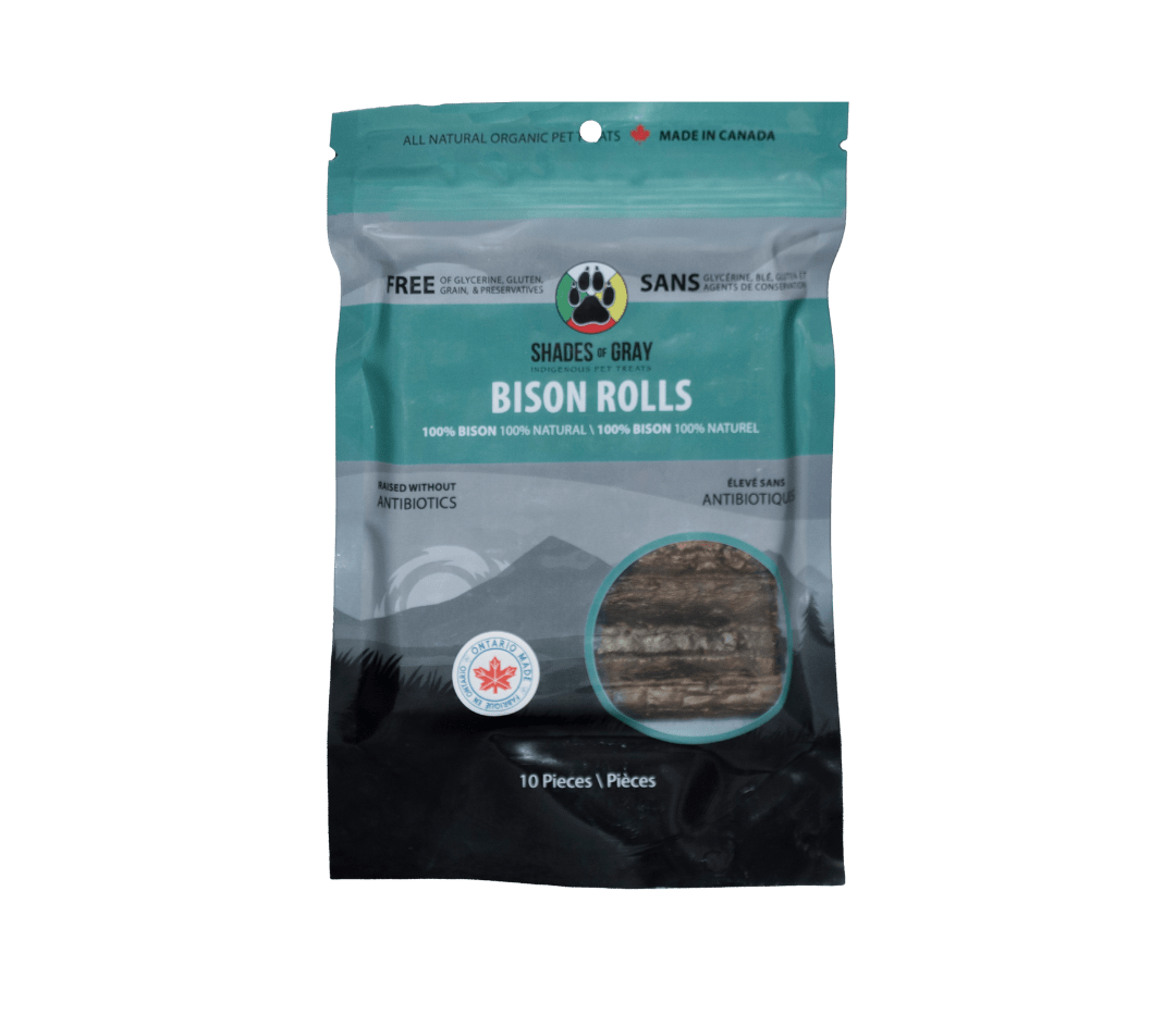 Front of a teal Shades of Gray Bison Rolls resealable bag, 10 pieces, with a window showing single-ingredient dehydrated bison rolls. 100% bison, raised without antibiotics, Ontario Made. This is the resealable bag in the Bison Rolls Eco Refill, ready to top up from the 30-roll refill pouch.