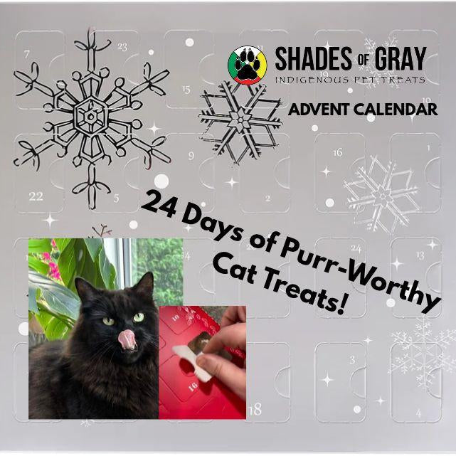 Shades of Gray Cat Christmas Advent Calendar: a black cat licks its lips as a treat is pulled from a numbered door. 24 days of cat treats.